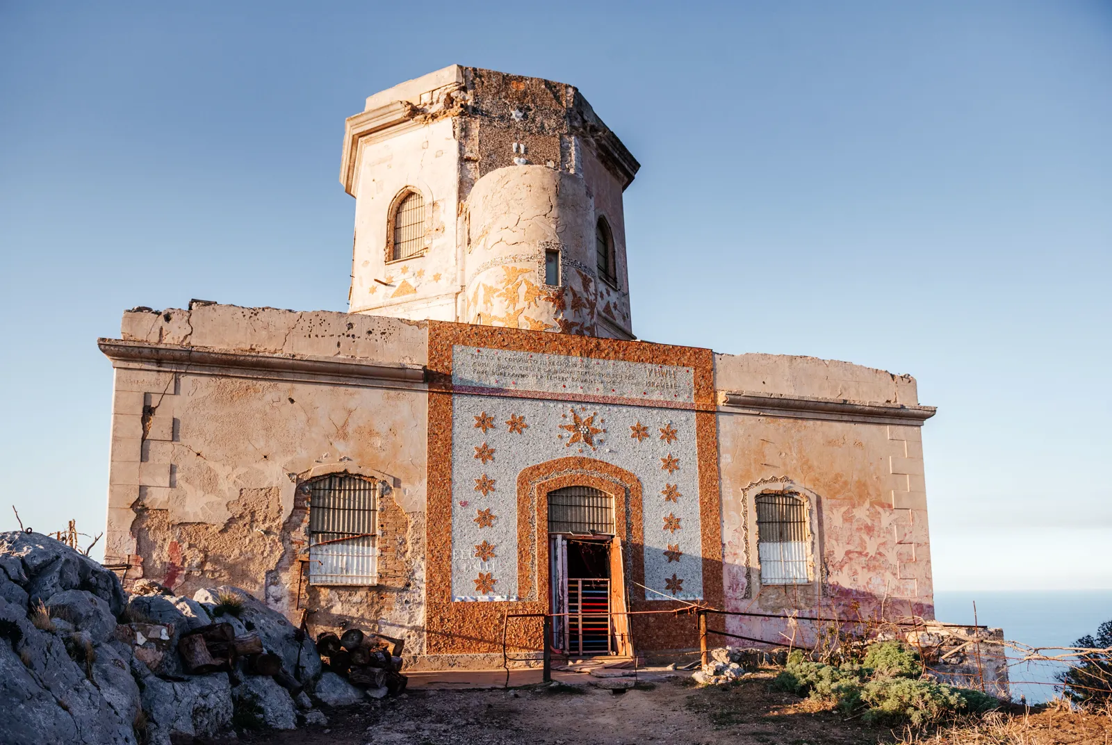 The mosaic-decorated facade and arched doorway of the Semaforo dell'Eremita with its octagonal lookout tower above